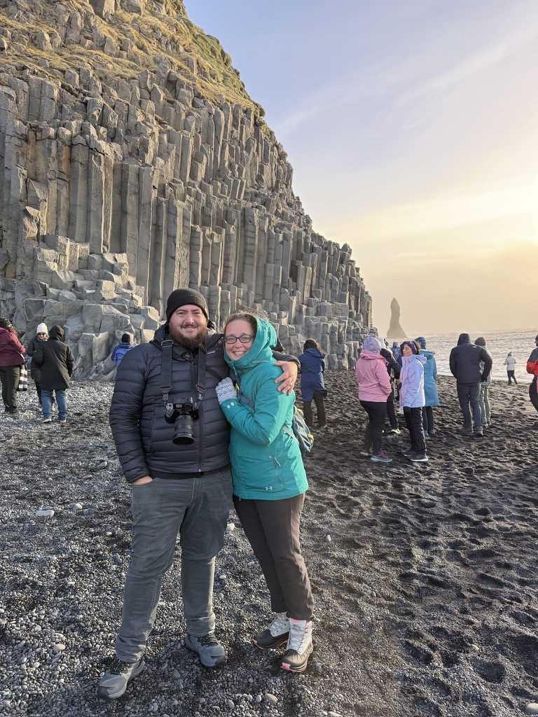 Josh and Katie LeClair below basalt columns on Iceland's black sand beach