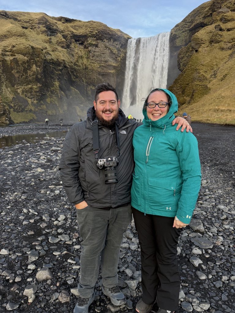 Josh and Katie LeClair in front of a waterfall in Iceland