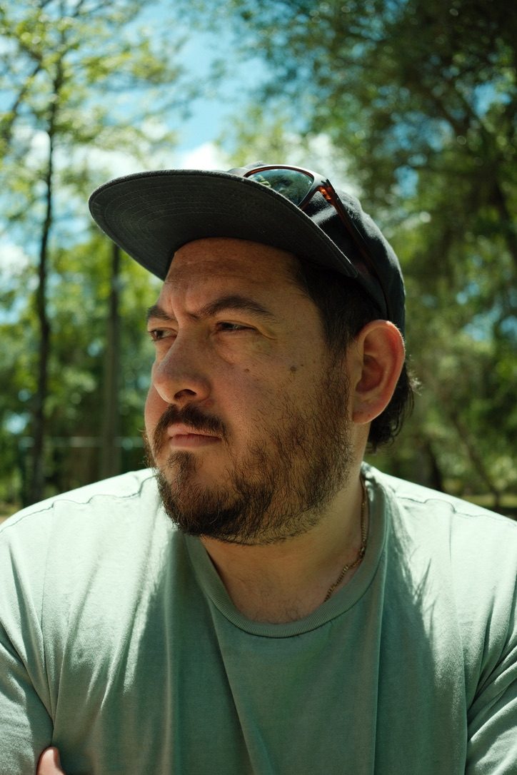 Portrait of Josh LeClair under the trees on a summer day
