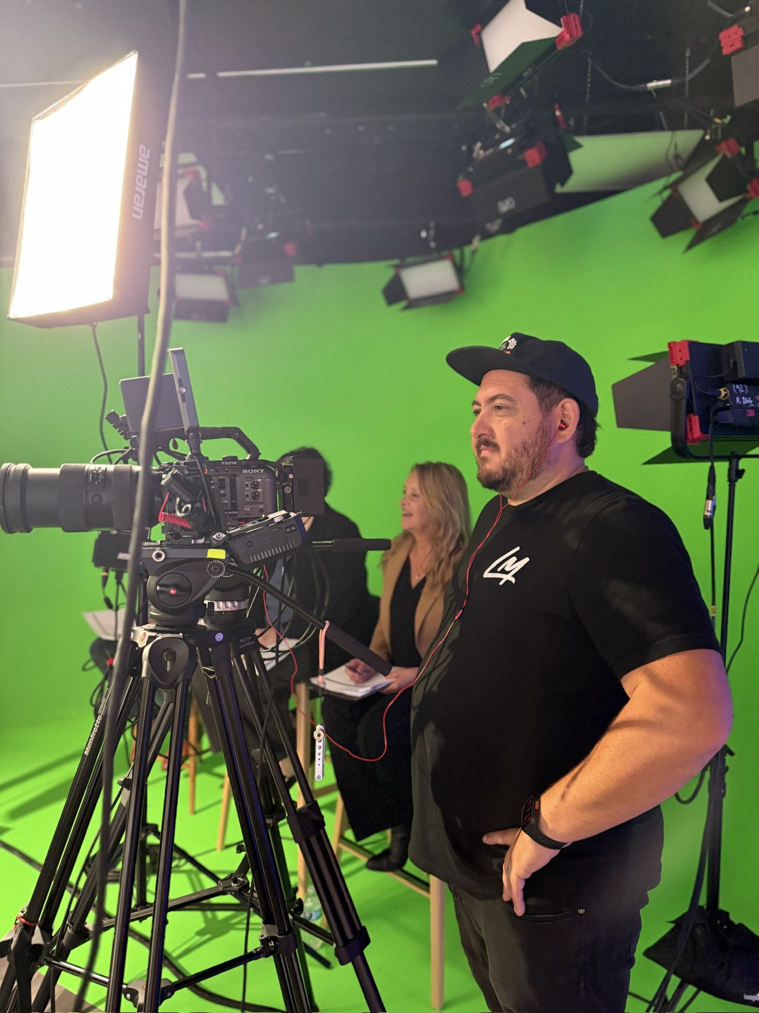 Josh LeClair on a green screen set behind a Sony cinema camera
