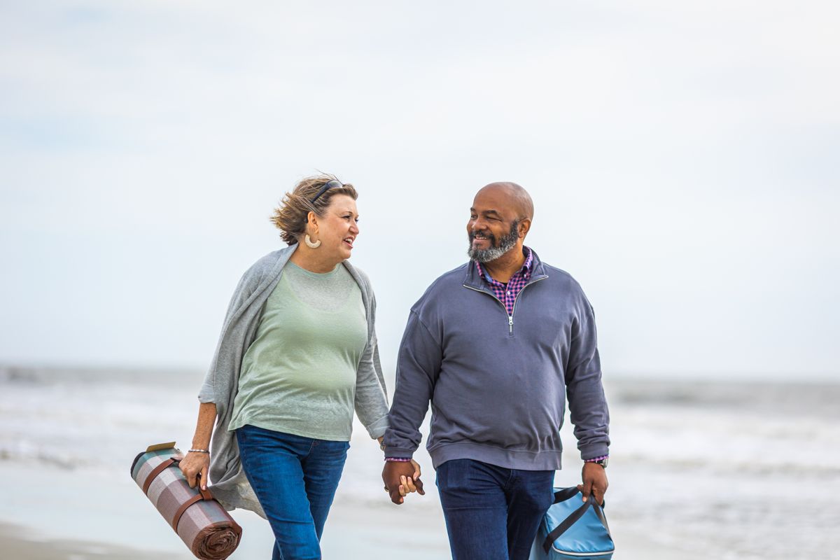 Couple strolling the beach on a camping weekend