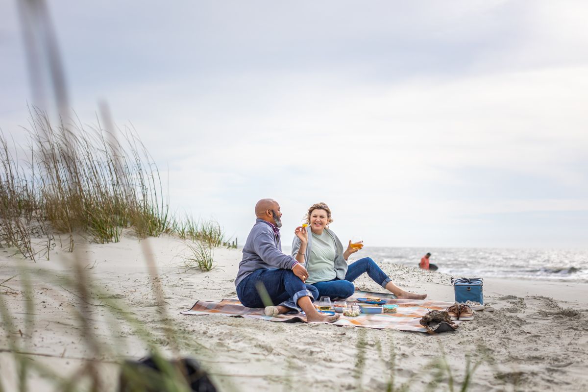 Friends picnicking on a quiet beach