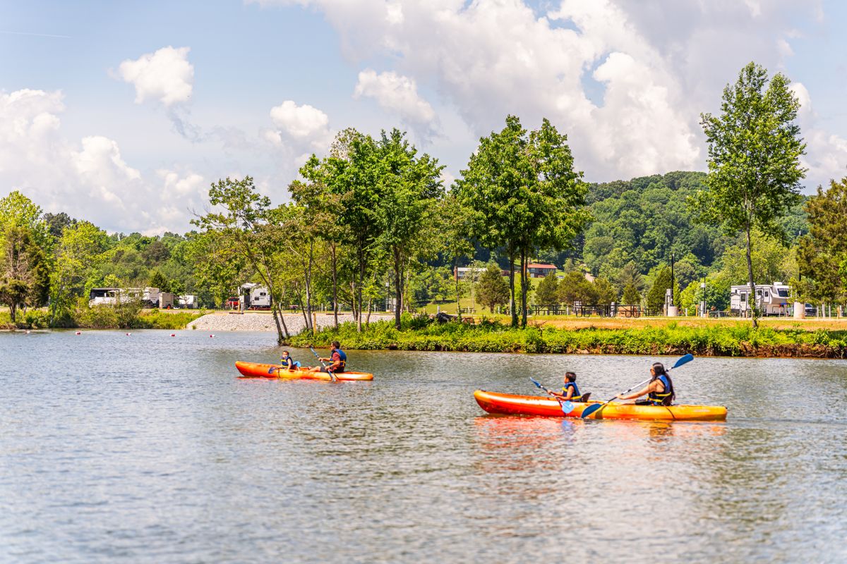 Kayakers paddling a calm lake on a summer day