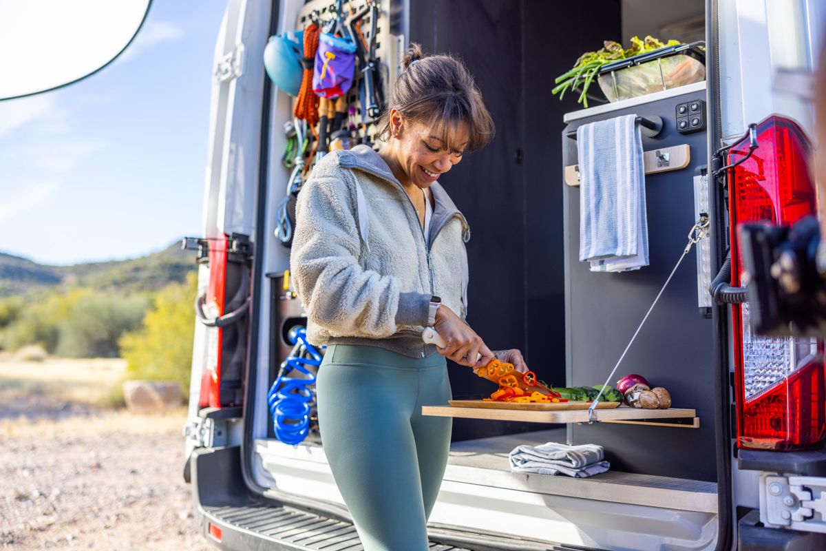 Cooking dinner outside a camper van in the desert
