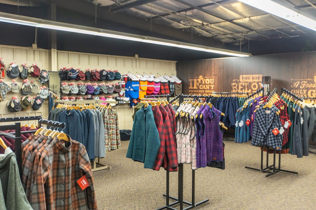 Workers sewing and finishing outdoor apparel on a factory floor