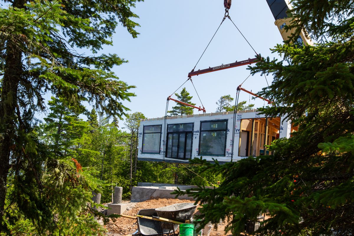 Crane setting a modular home section on build day
