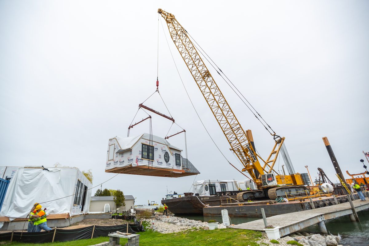 Crane setting a modular home section on build day