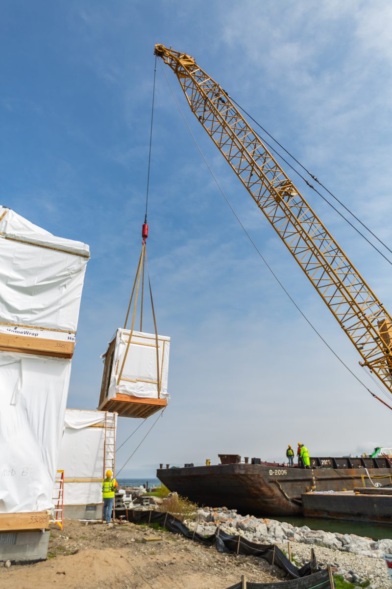 Crane setting a modular home section on build day