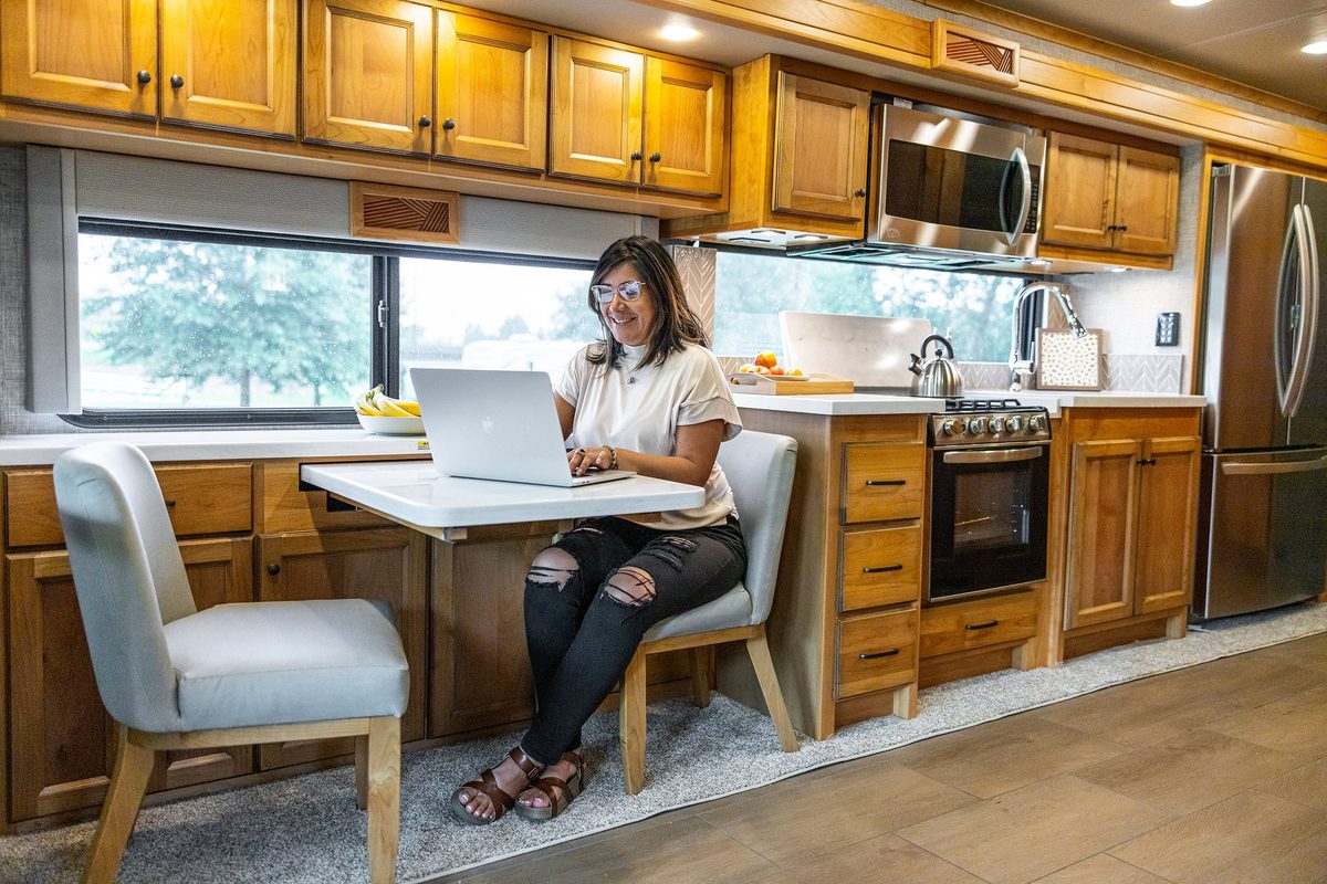 Luxury motorhome interior with kitchen, living area and cabin details