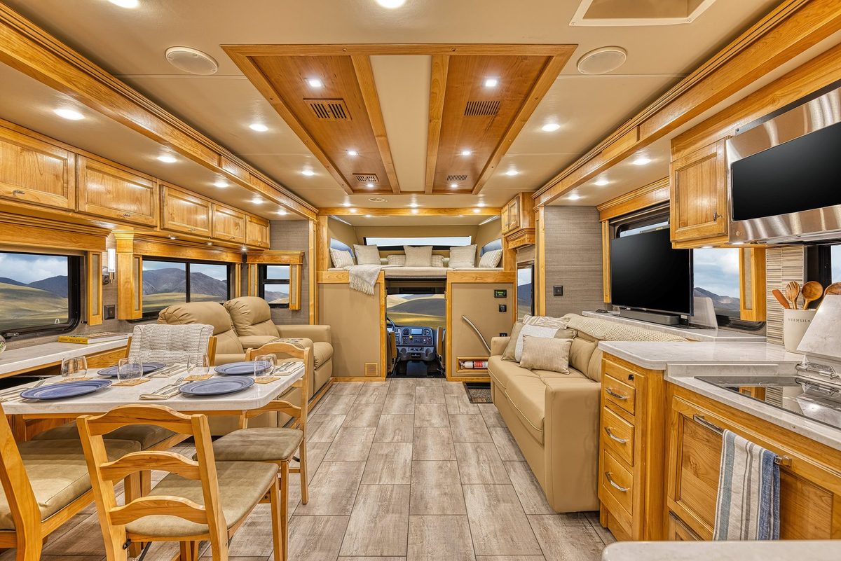 Luxury motorhome interior with kitchen, living area and cabin details