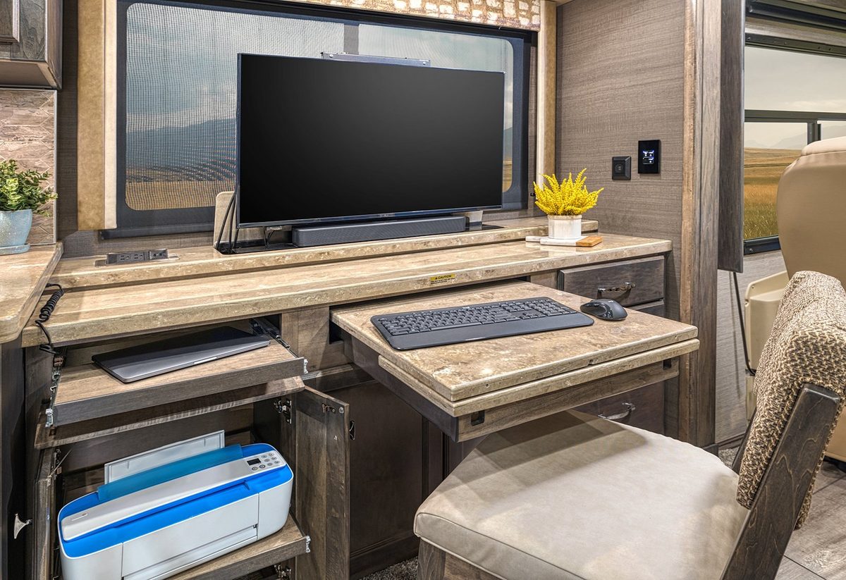 Luxury motorhome interior with kitchen, living area and cabin details