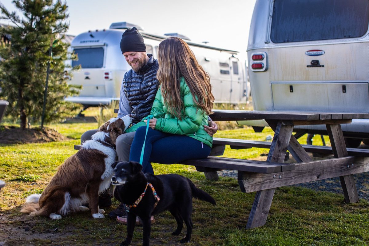 Family camping beside a lake with their motorhome