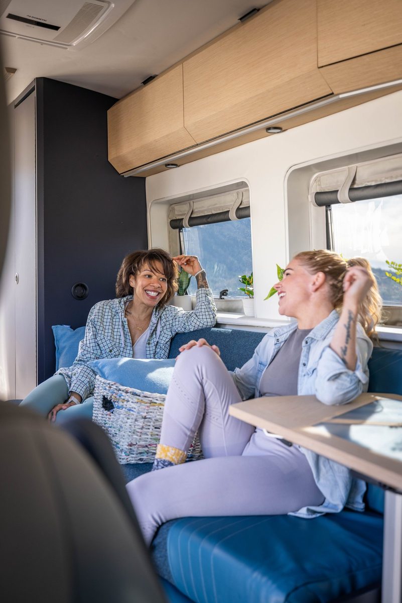 Couple traveling in a camper van on a mountain road trip