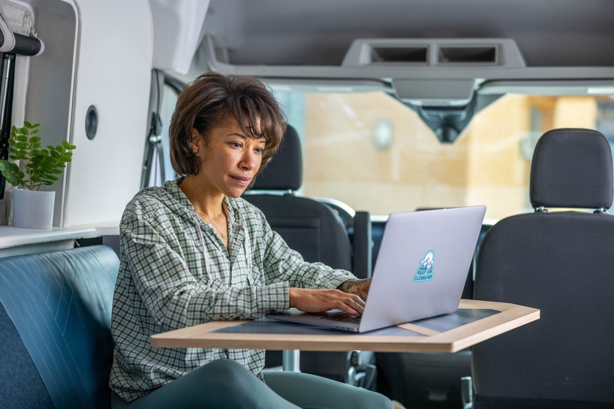 Couple traveling in a camper van on a mountain road trip