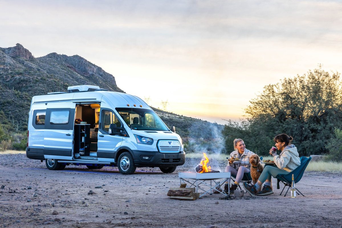 Couple traveling in a camper van on a mountain road trip