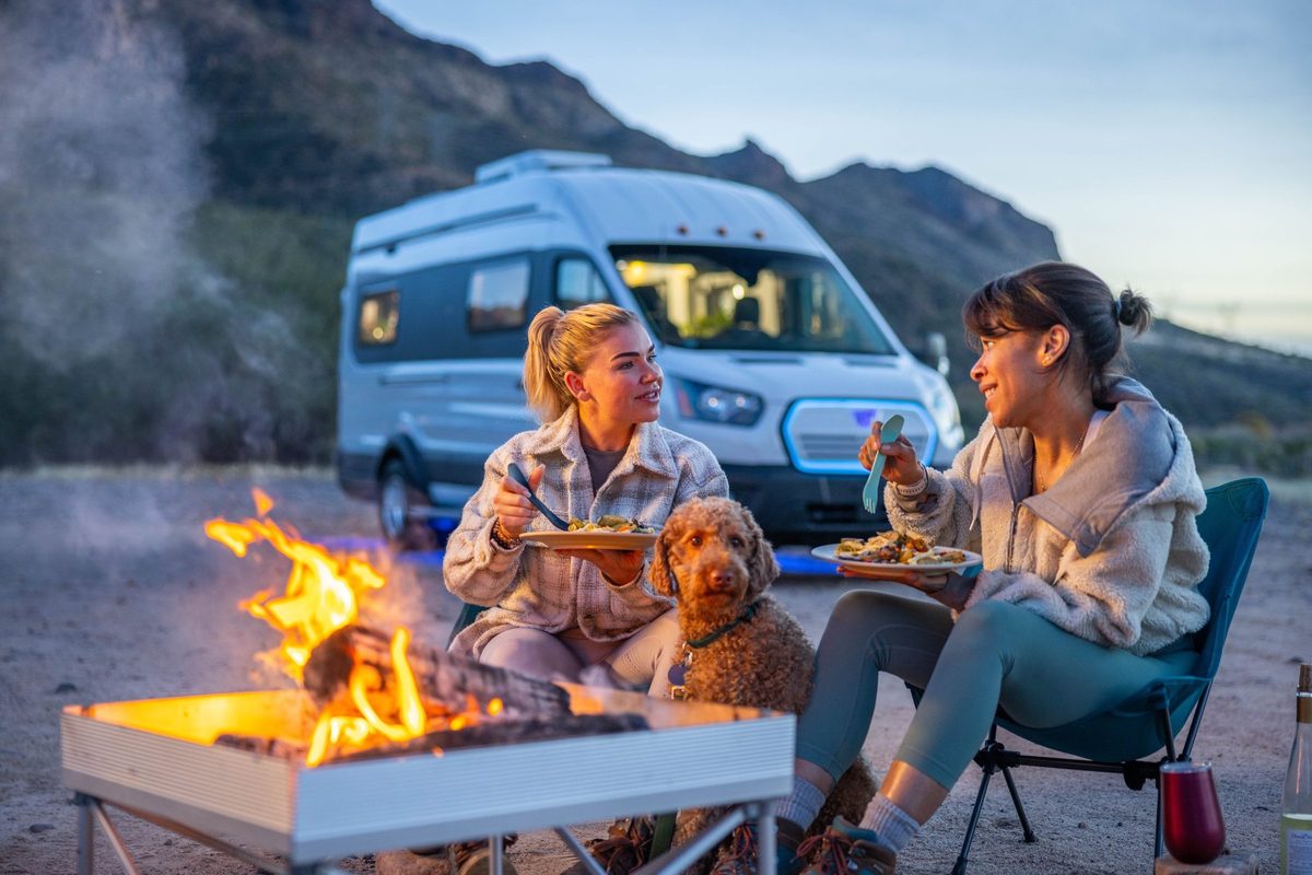 Couple traveling in a camper van on a mountain road trip