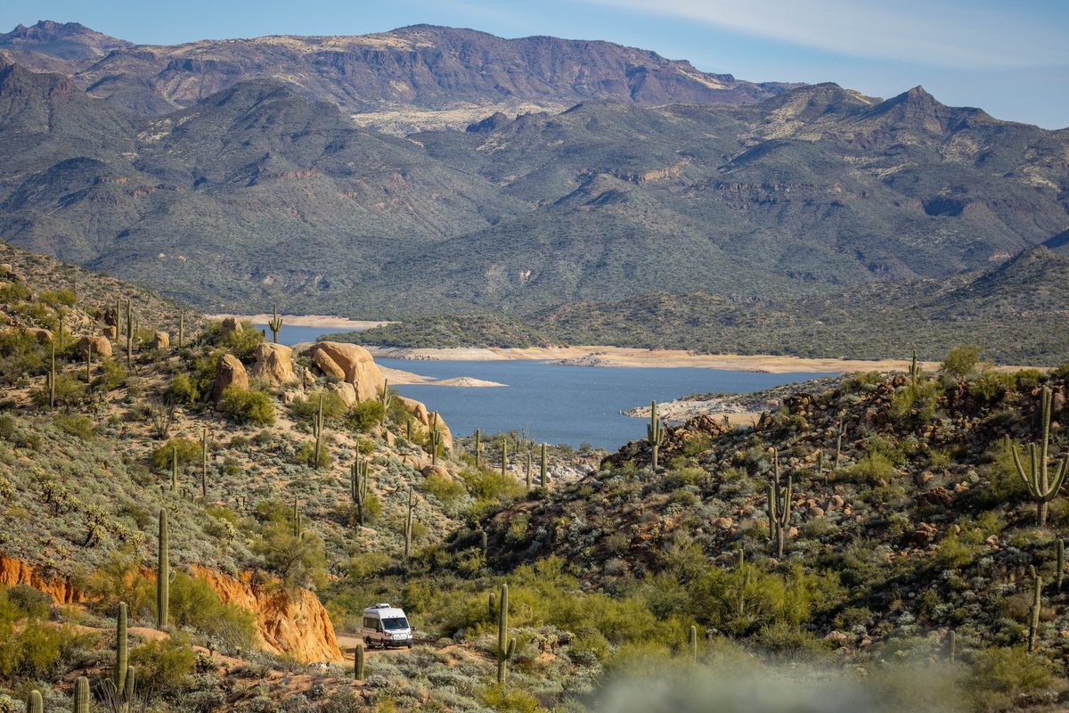 Couple traveling in a camper van on a mountain road trip