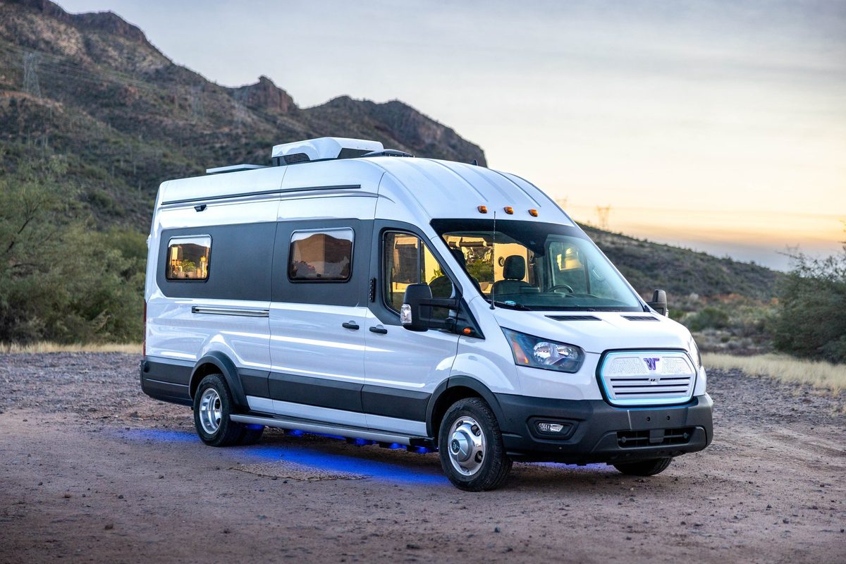 Couple traveling in a camper van on a mountain road trip