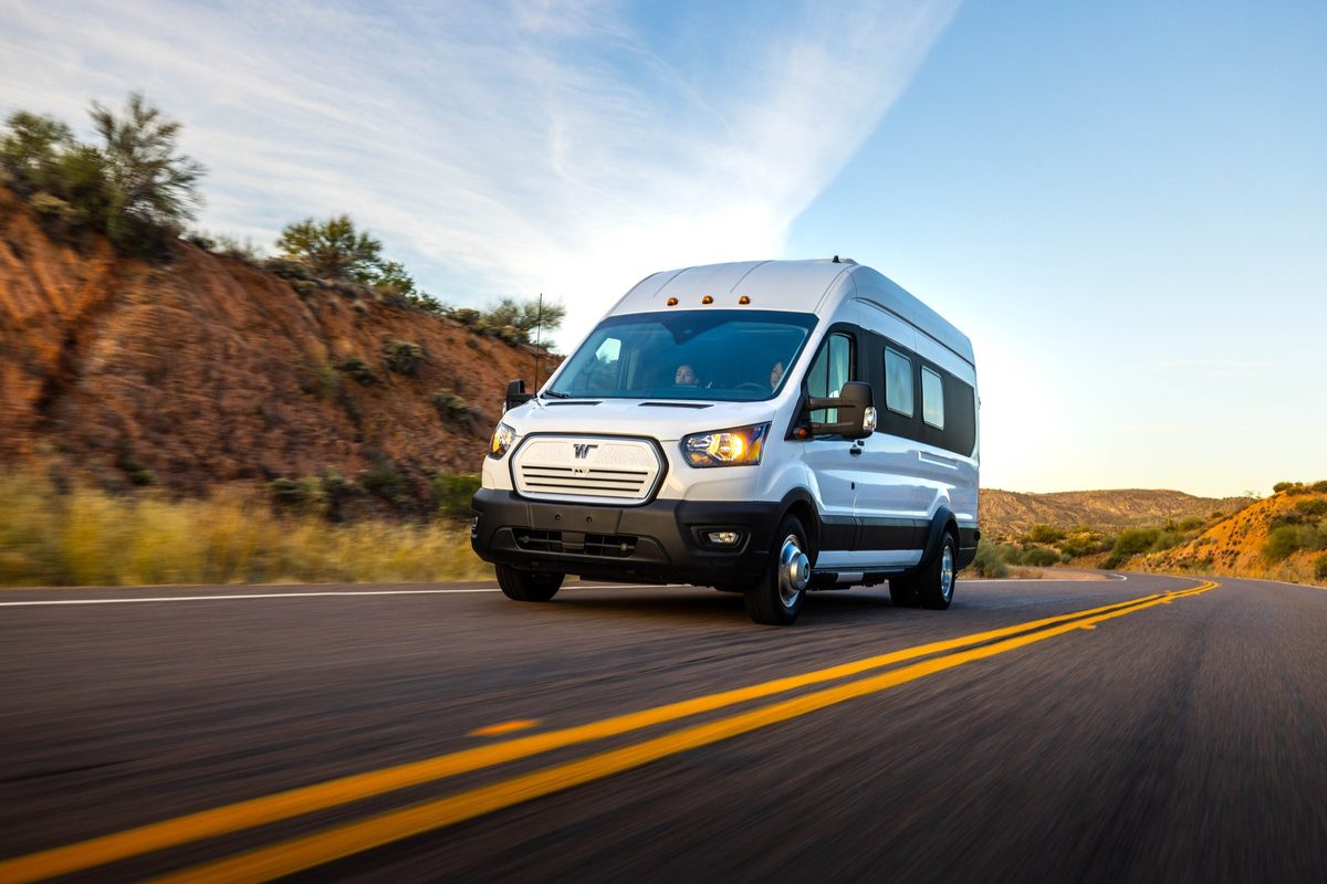 Couple traveling in a camper van on a mountain road trip
