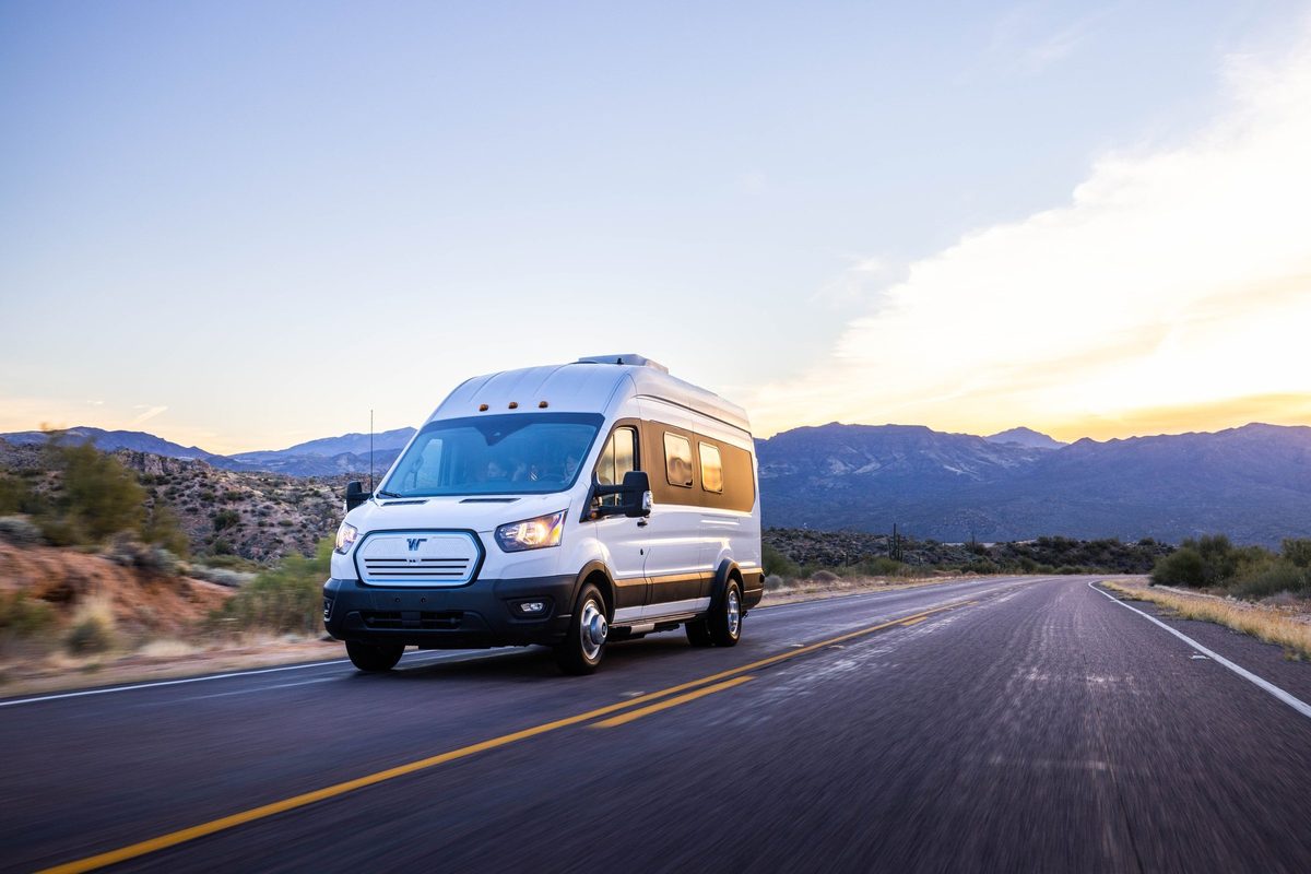 Couple traveling in a camper van on a mountain road trip