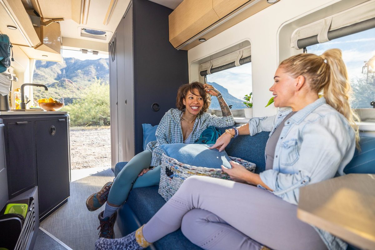 Couple traveling in a camper van on a mountain road trip
