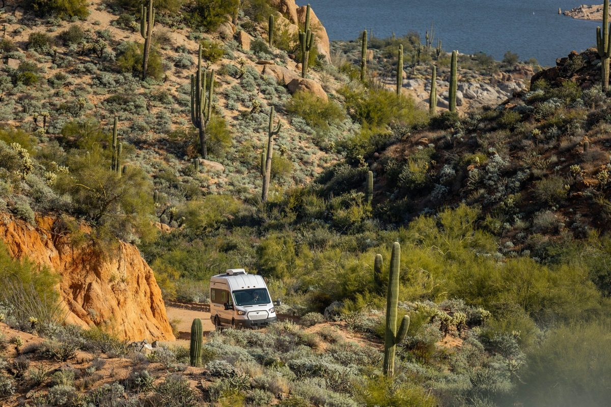 Couple traveling in a camper van on a mountain road trip