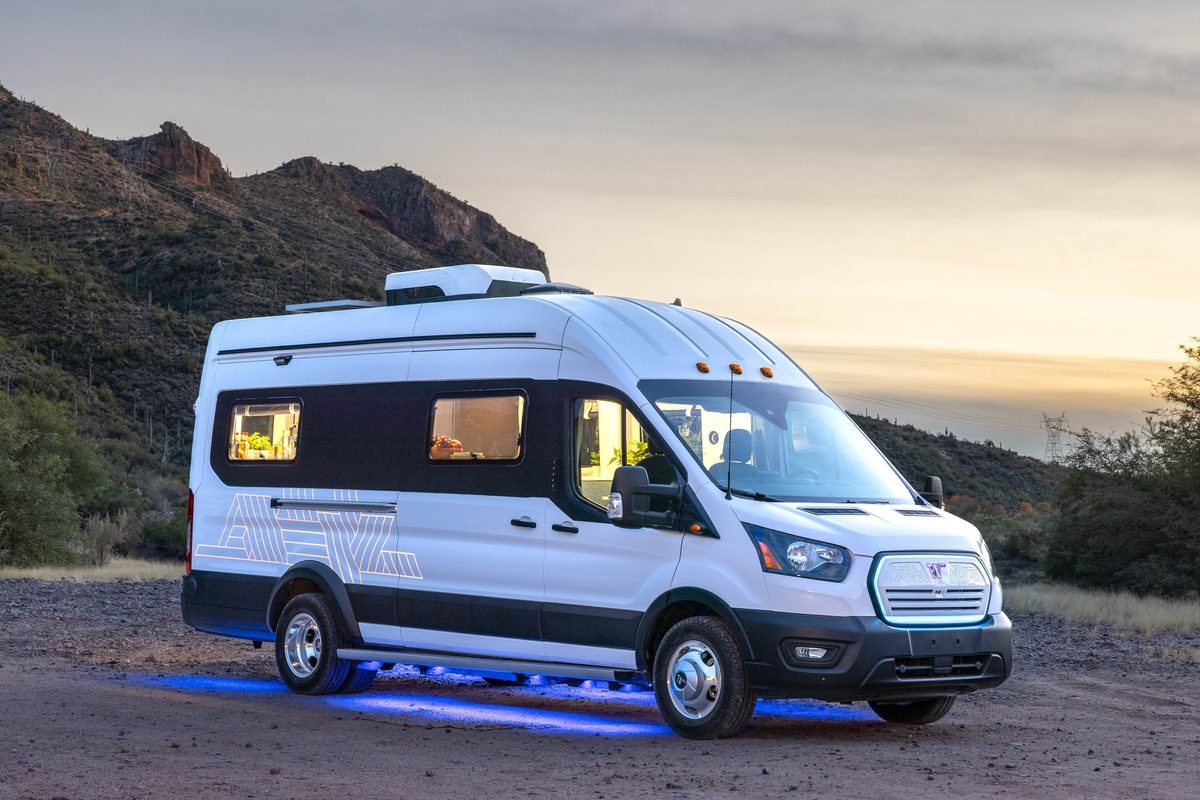 Couple traveling in a camper van on a mountain road trip